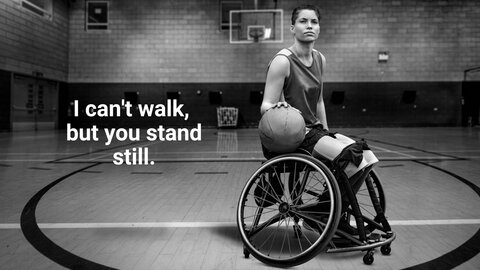 A woman in a wheelchair bounces a basketball. | © EnableMe